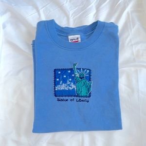 Blue embroidered Statue of Liberty t shirt.
